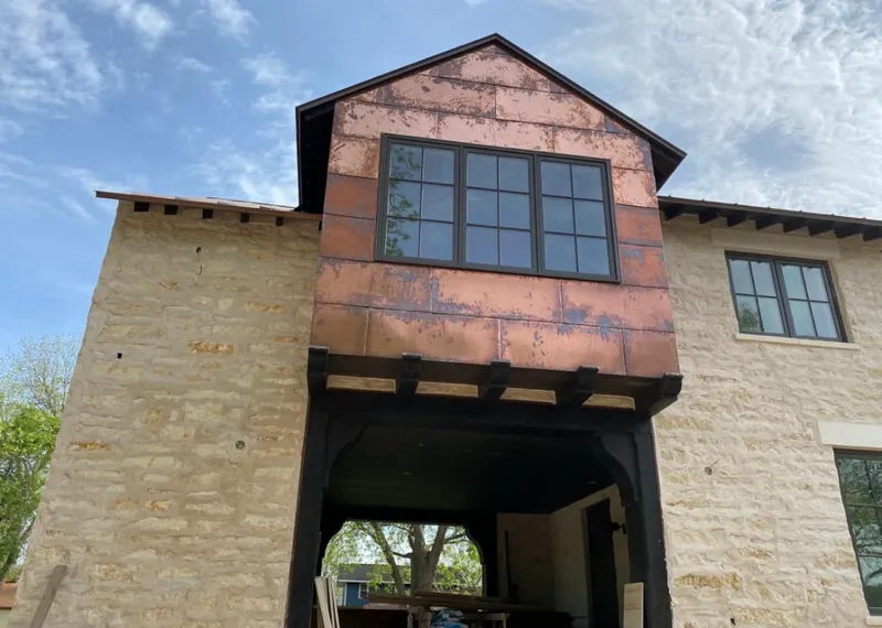 Copper metal panel facade on a stone building for Skylight Installation in Calexico