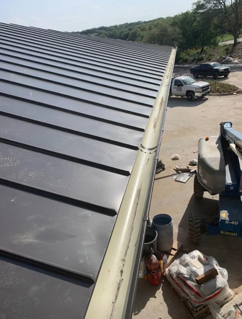 Standing seam panel and gutter detail on a metal roofing jobsite in Calexico
